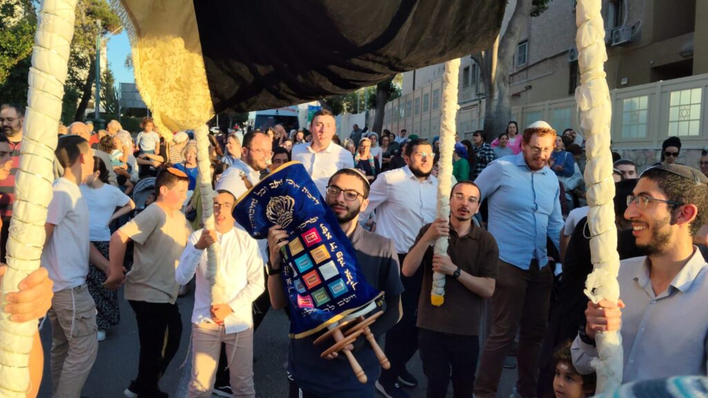 איתן מאיר סבג רוקד עם ספר התורה.