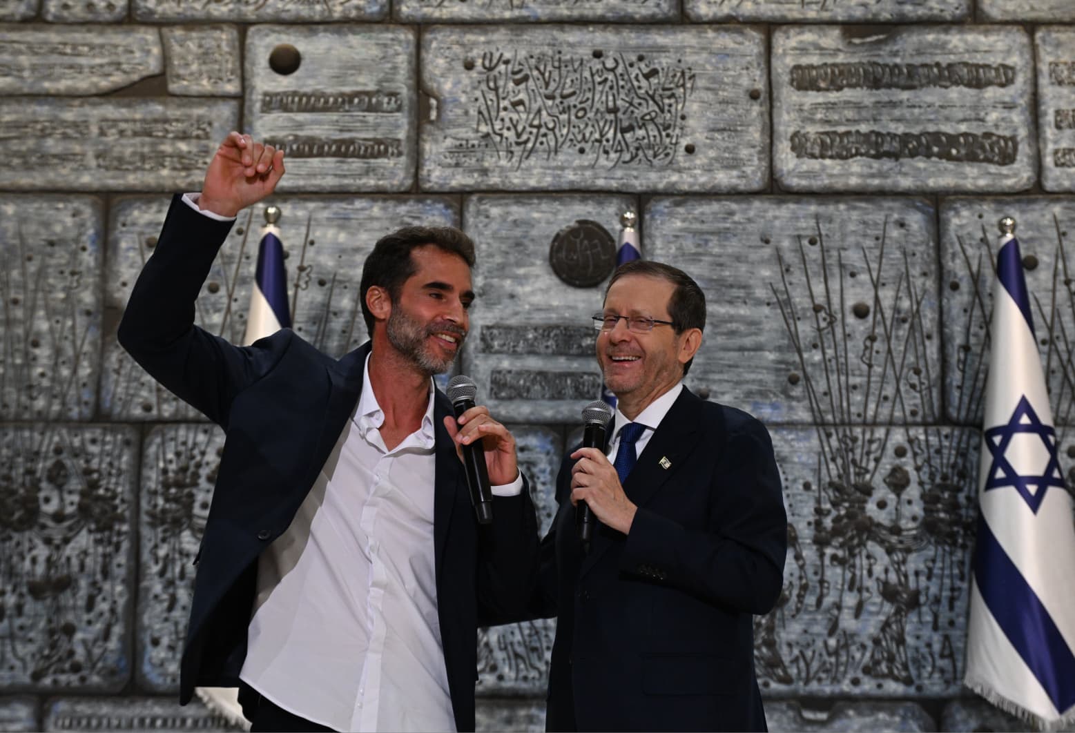 הנשיא הרצוג עם מעוטר מניף אגרוף בשמחה